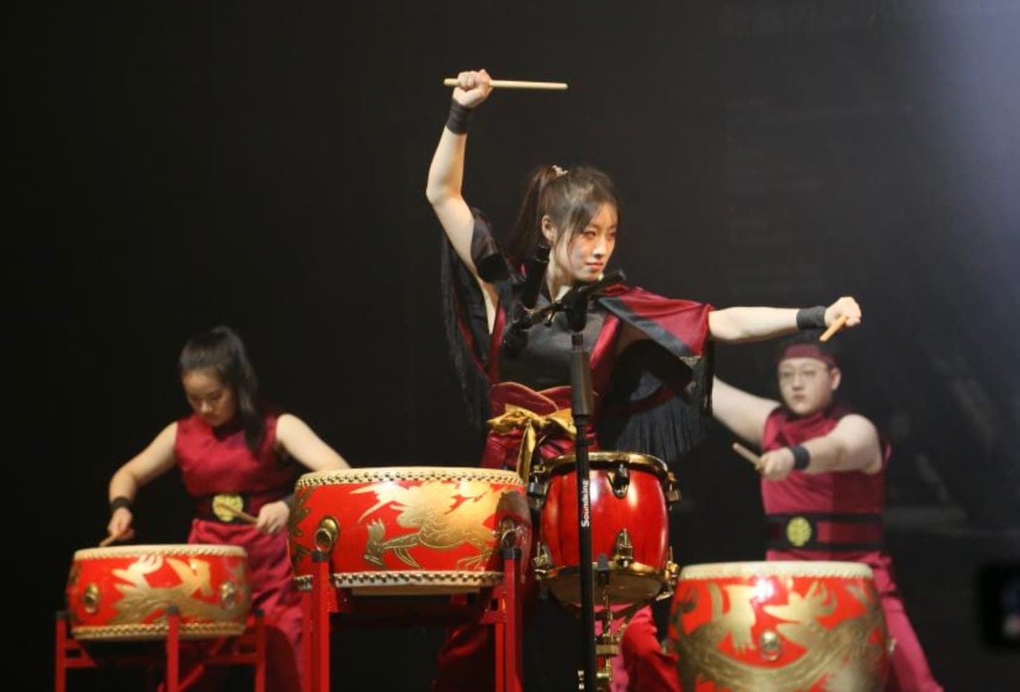 Chinese ceremonial drummers mid-strike