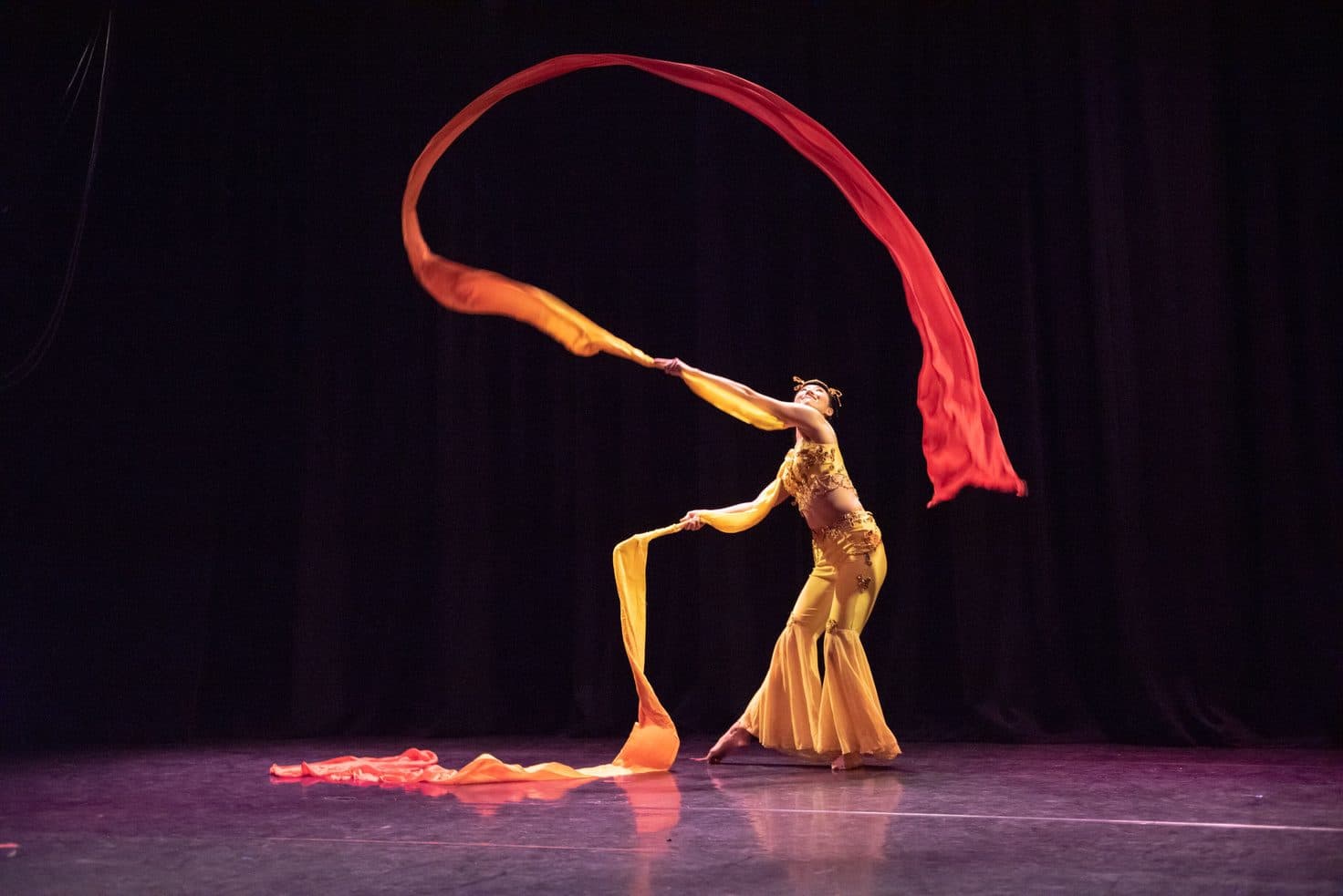 Dancer sweeping a long silk ribbon overhead