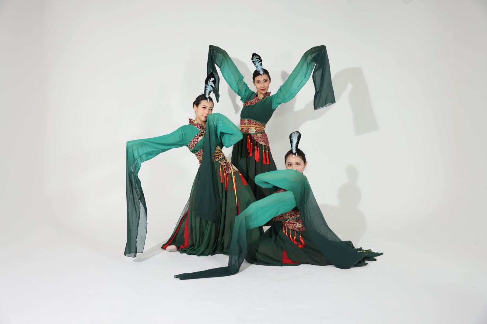Water-sleeve dancers mid-movement