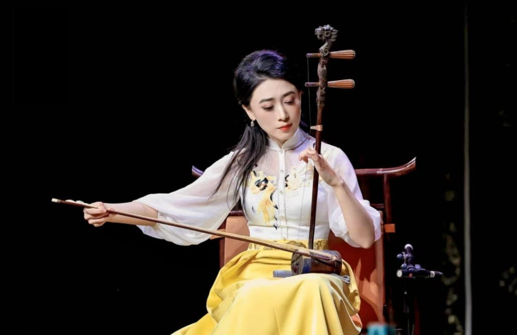 Erhu player bowing the two-string fiddle