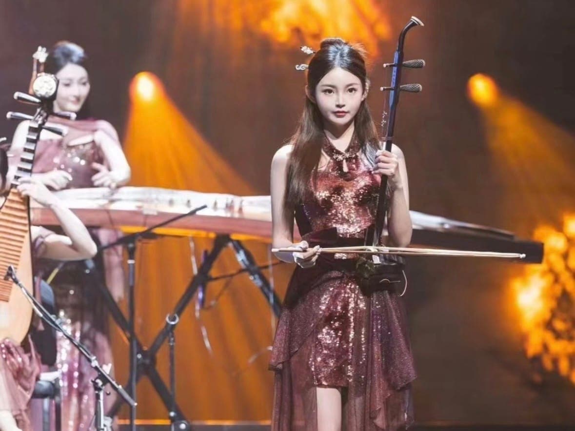 Female Erhu artist performing on stage in stand position