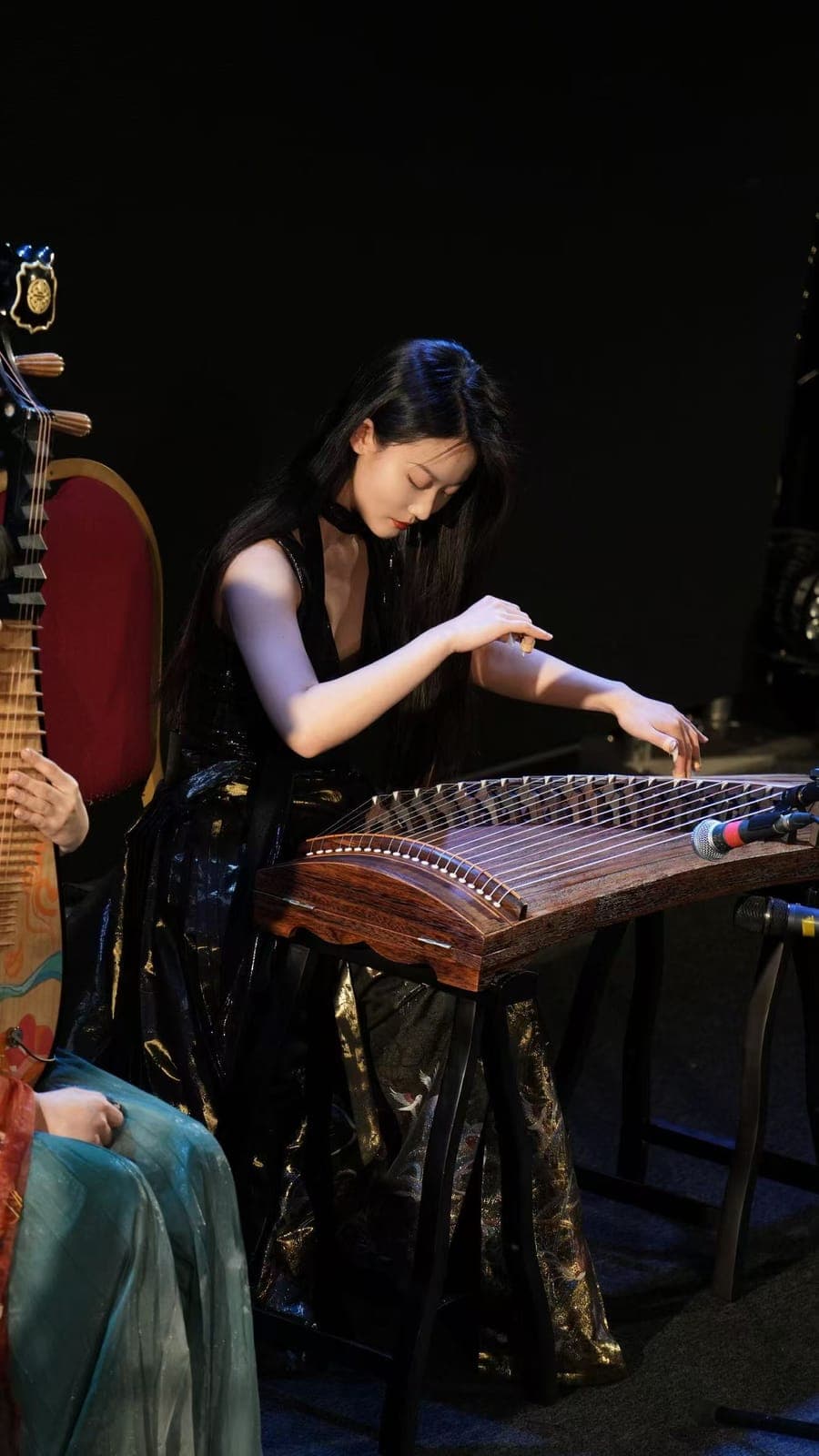Guzheng player at the instrument