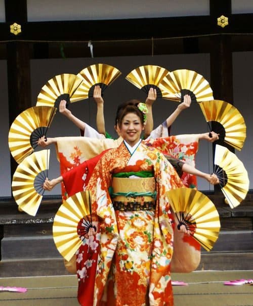Japanese fan dancers in a gold starburst formation