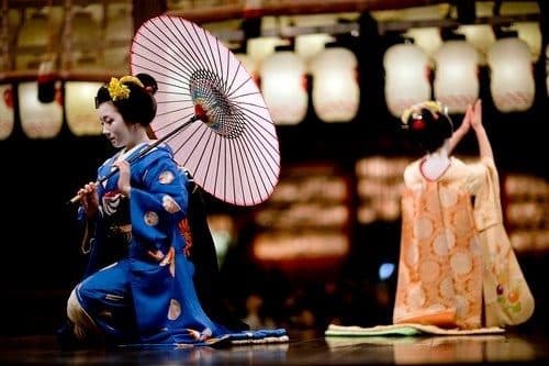 Dancers beneath hanging paper parasols
